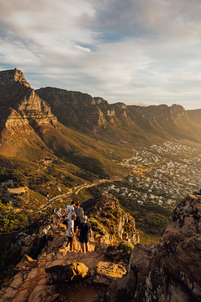 why-choose-us A breathtaking sunset view from Lion's Head with hikers enjoying the scenic landscape in Cape Town.